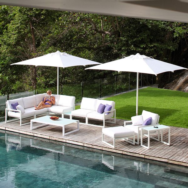 Image of white Shady parasols and white Ninix sofas around poolside by Royal Botania