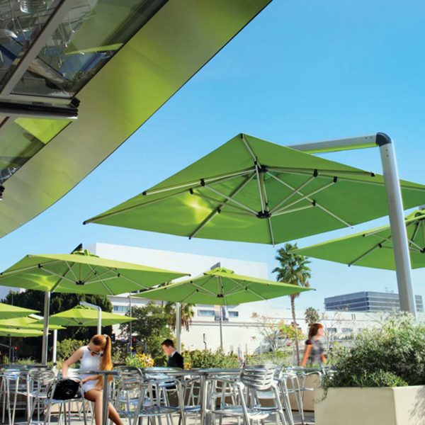 Image of Shademaker Orion cantilever parasols with lime green canopies shown above bistro furniture