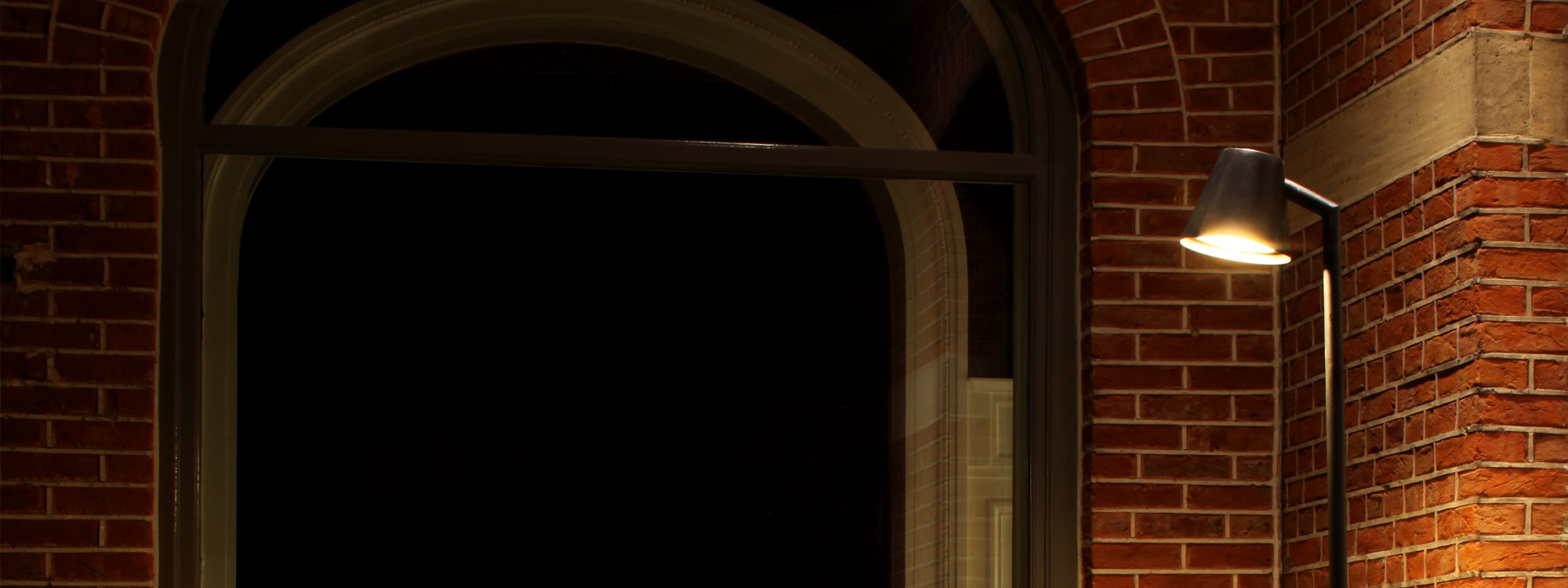 Nighttime image of Royal Botania Parker exterior floor lamp in antique brass