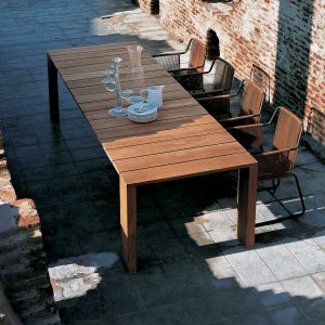 Birdseye view of Pier teak table and Harp garden chairs in sunny courtyard.