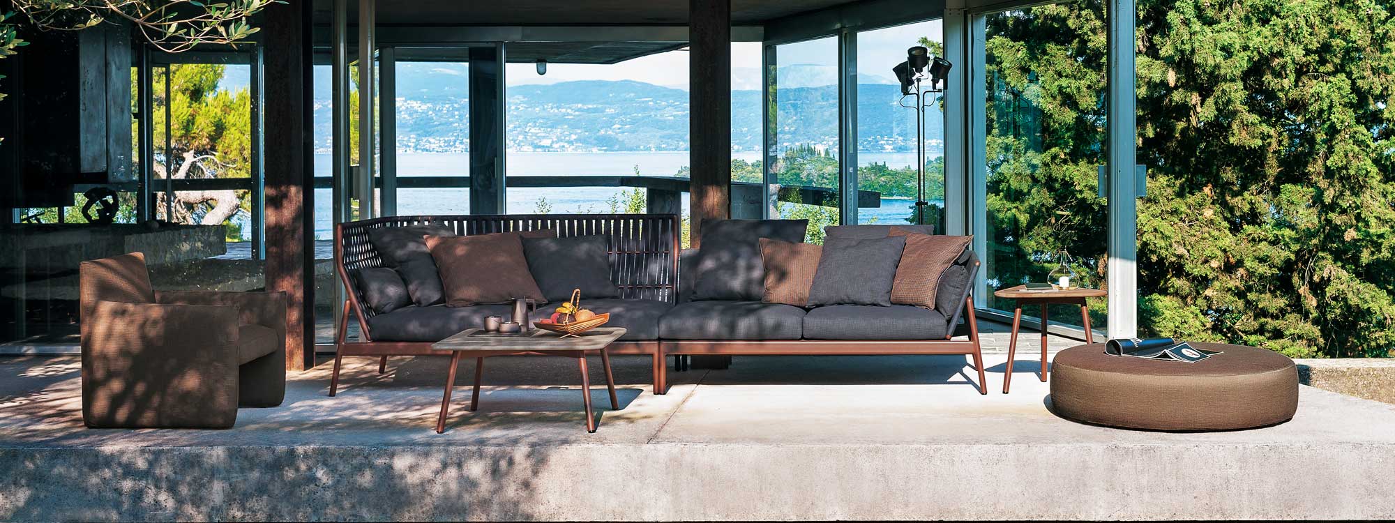 Image of Piper large garden sofa with both high back and low back, with rust-colored frame and dark grey cushions
