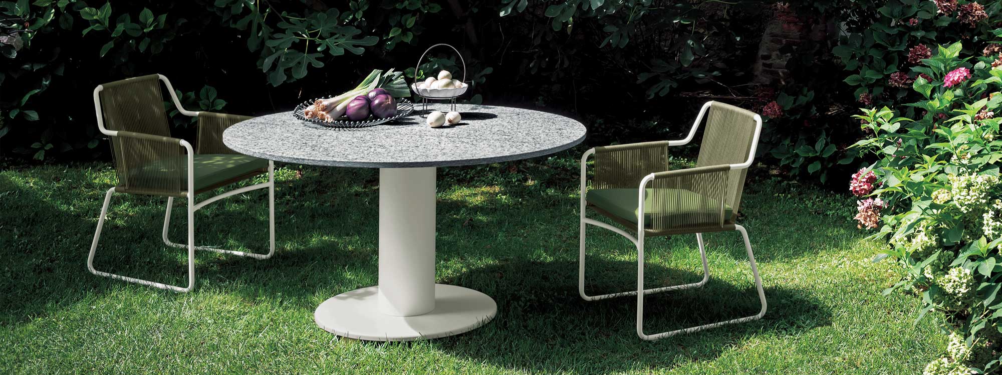 Image of RODA Platter circular garden pedestal table with white stem bas and grey stone table top, together with white Harp garden chairs