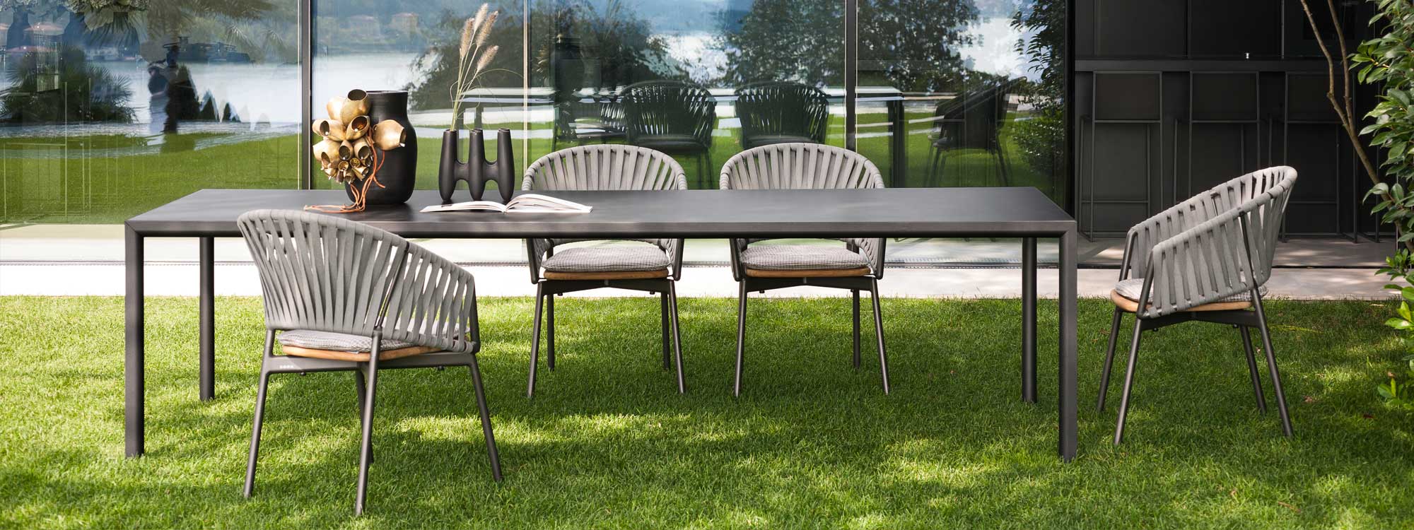 Plein Air minimalist table with Piper garden chairs on grassy lawn