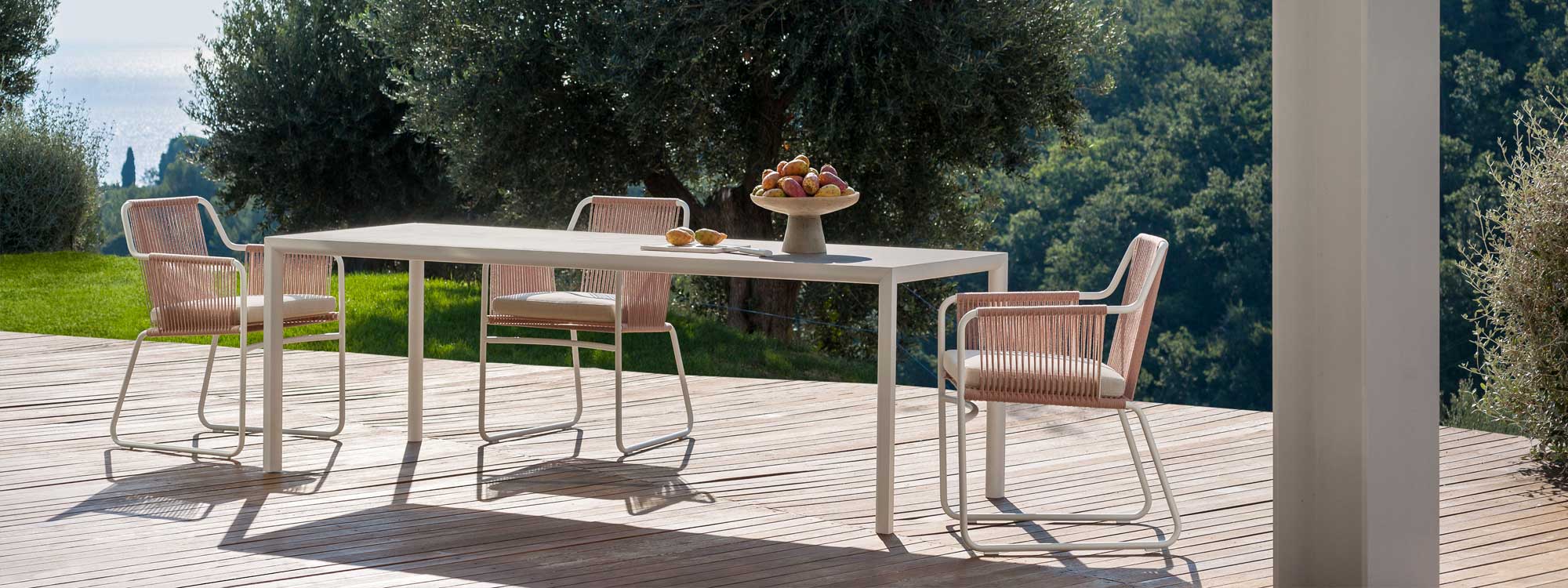 Harp exterior carver chairs & Plein Air minimalist dining table on wooden decking