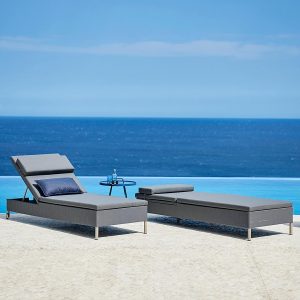 Image of pair of Caneline Rest adjustable sunbeds on poolside with sea in background