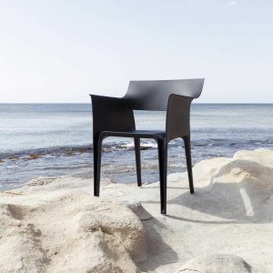 Image of Vondom Pedrera recycled plastic bistro chair on rocks with sea and sky in the background