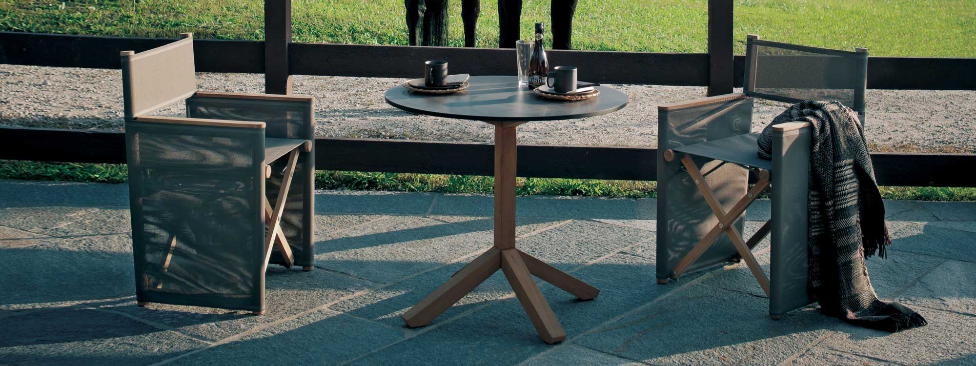 Image of Root small teak table with grey HPL top, together with pair of Orson garden director chairs by RODA