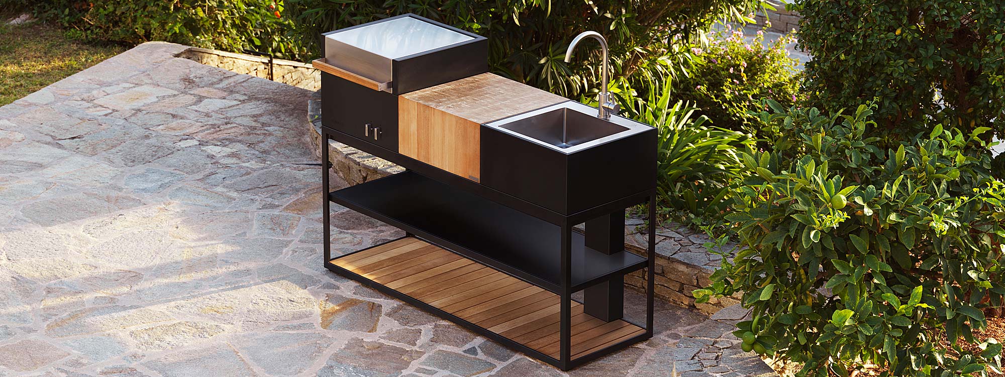 Image of aerial view of Roshults Open Kitchen minimalist bbq in anthracite coloured stainless steel, and outdoor sink with teak chopping board
