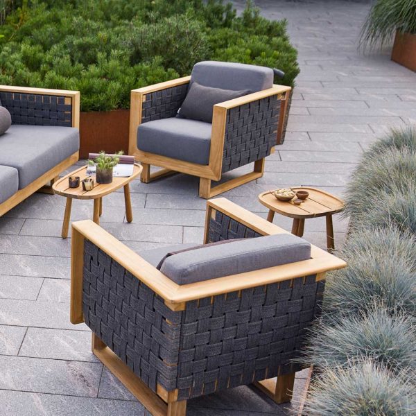 Image of pair of Angle upholstered teak lounge chairs and Angle teak sofa with Royal Teak side tables by Caneline garden furniture