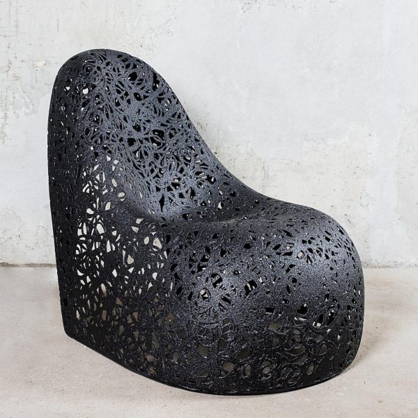 Image of side view of Self easy chair by Unknown Nordic, showing the chair's flowing curves
