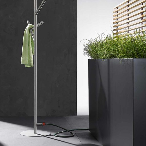 Image of Sotomon minimalist raised planter with trellis, next to stainless steel garden shower by Conmoto