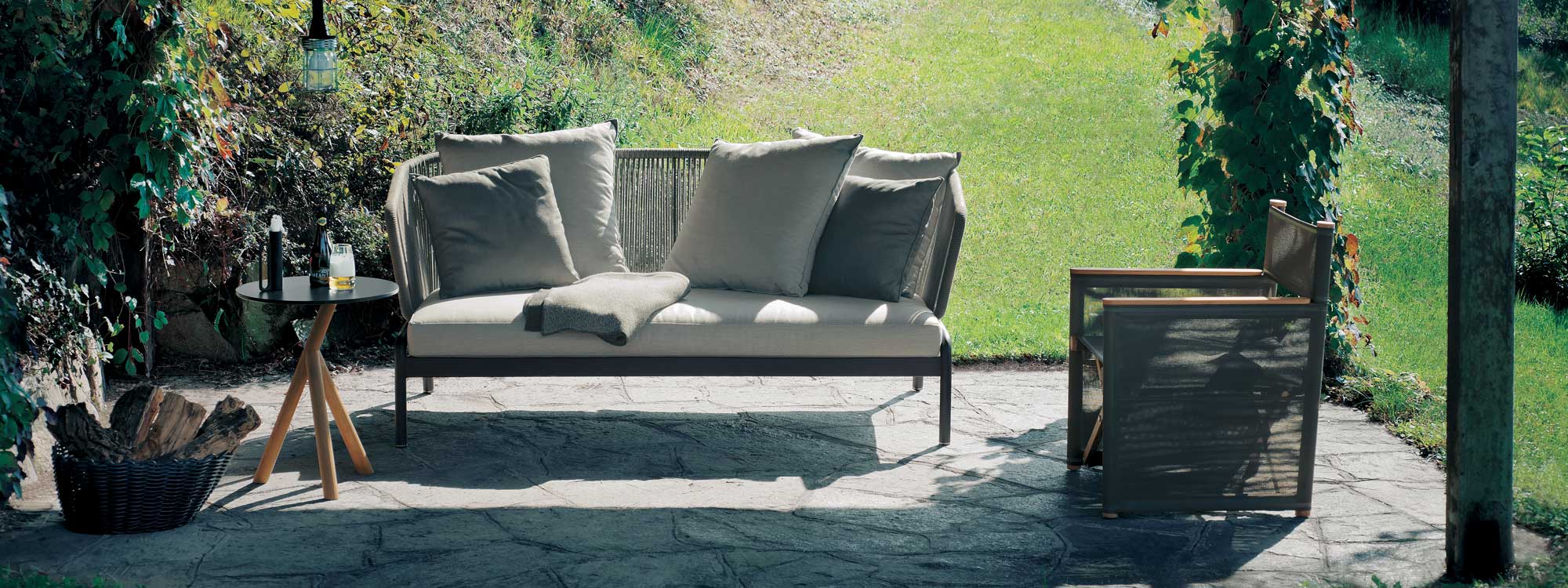 Spool modern outdoor sofa and Orson folding lounge chair on terrace