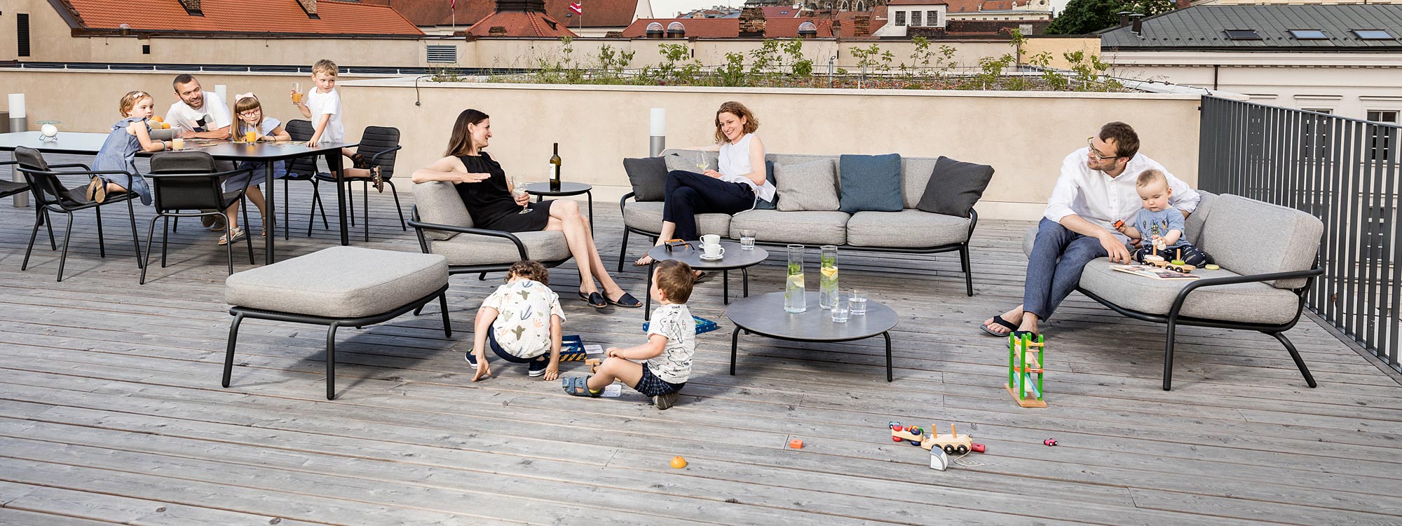 Image of young families relaxing on Starling garden sofas on rooftop terrace