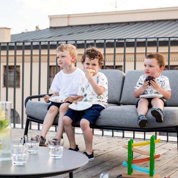Kids eating cake sat on Starling modern outdoor sofa