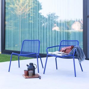Vibrant blue finish of Starling modern outdoor low chairs is an ergonomic garden lounge chair by Studio Segers for Todus stainless steel garden furniture company