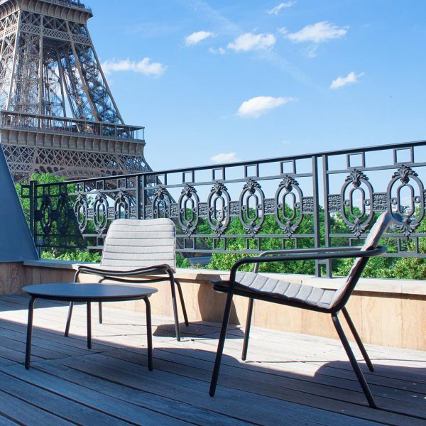 Image of Paris rooftop with Starling outdoor relax chairs and low tables, with the Eiffel Tower in the background