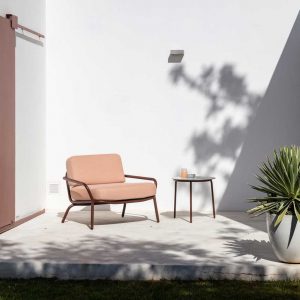 Rust-Brown coloured Starling lounge chair in sunny courtyard