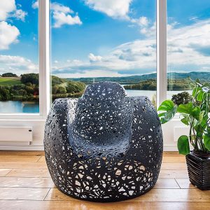 Interior image of black Stellar armchair, by Unknown Nordic furniture, with lake and hills in background