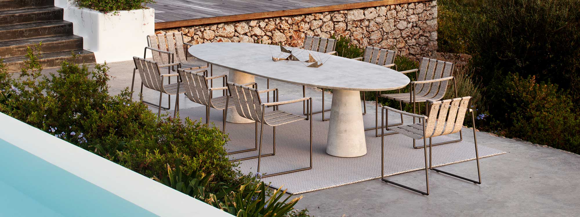 Image of Royal Botania Strappy chair & Conix elliptical concrete table