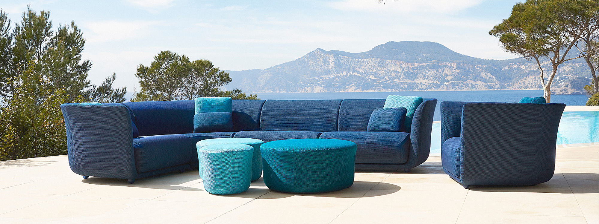 Image of Vondom Suave contemporary garden sofa in blue fabric by Marcel Wanders
