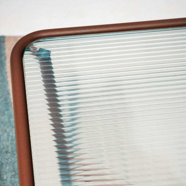 The ribbed glass table top of Sunglass garden low table gives the design a unique retro look