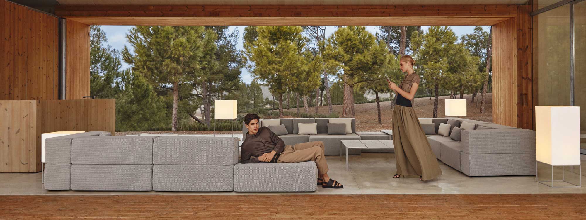 Image of couple posing on and around Vondom Tablet modular garden sofa