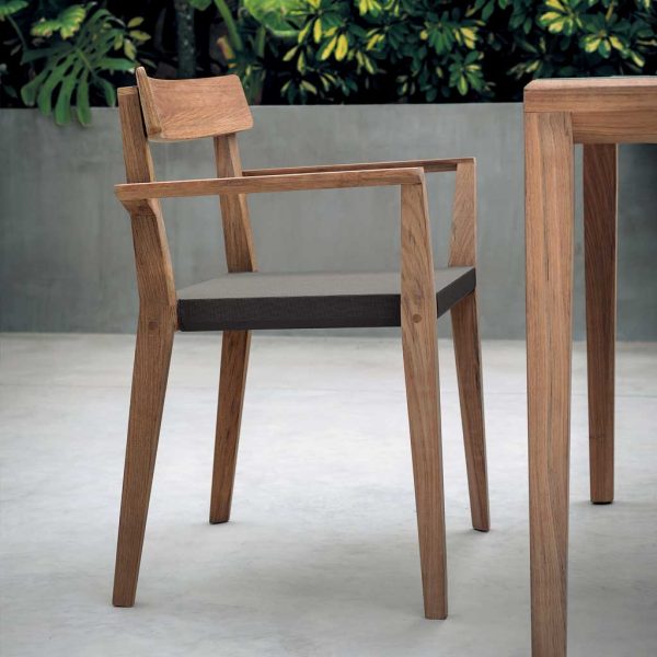 Image from side of RODA Teka teak dining chair with brown all-weather fabric seat, showing curved teak backrest and linear design of the hair's frame & legs