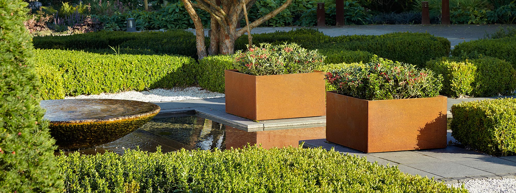 Thallo modern geometric planter is a powder coated or corten plant pot with watertight planting insert by Flora contract planter company.