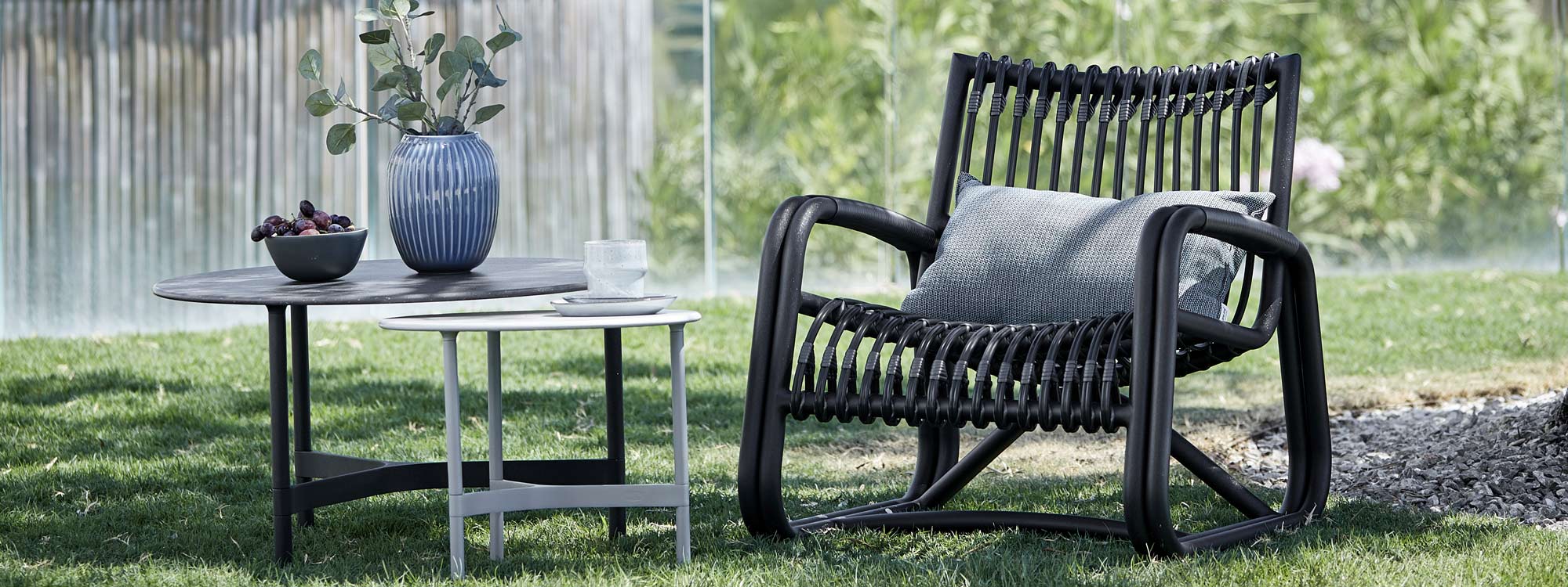 Image of nest of Twist outdoor low tables in black and white by Cane-line