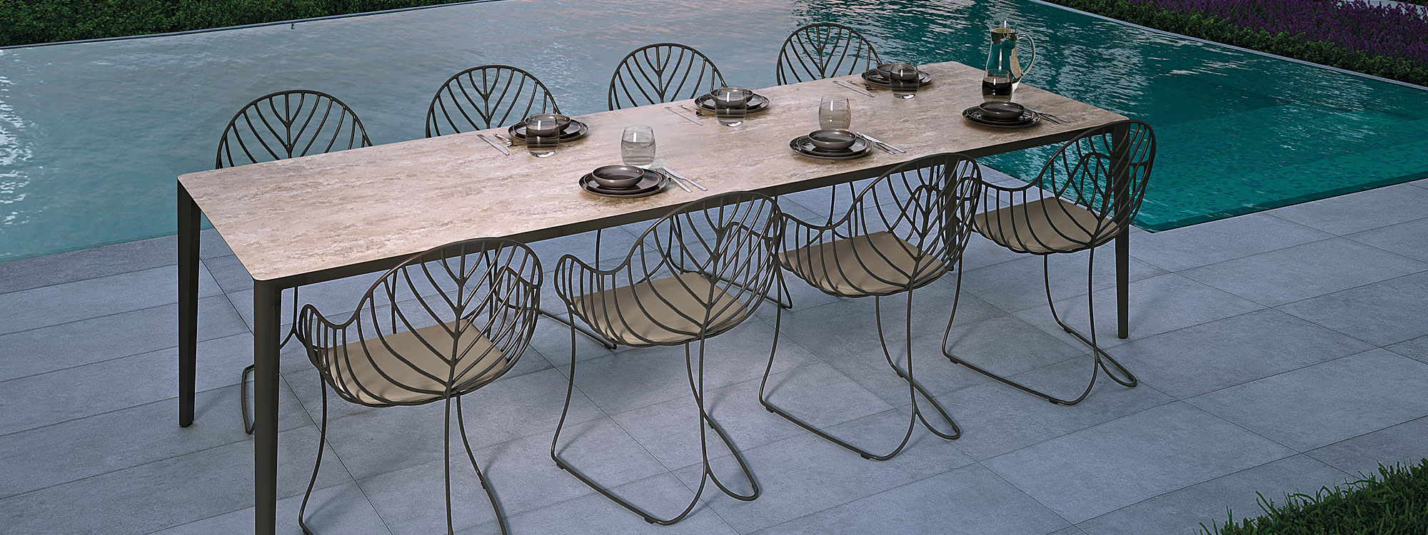 Image of bronze Folia chairs and U-nite table with bronze frame and Travertine ceramic table top by Royal Botania