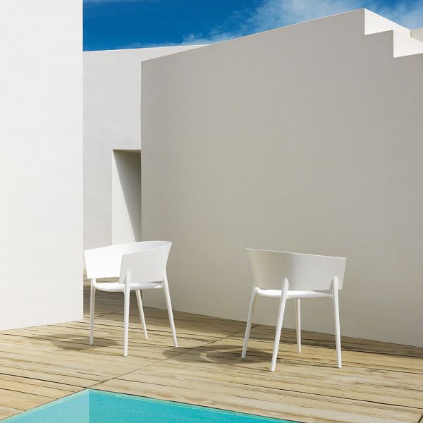 Image of pair of white Africa modern tub chairs by Vondom on sunny poolside