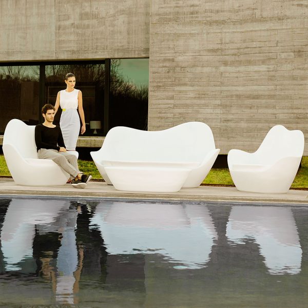 Lady Stood By White SABINAS Organic DESIGN Garden SOFAS Designed By Javier Mariscal. MODERN Outdoor LOUNGE Furniture & LED Lit Garden Furniture Collection Includes 3 Seat Sofa, Lounge Chair & Low Table, Made By VONDOM Designer Plastic GARDEN FURNITURE.