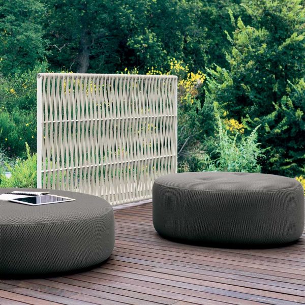 Image of RODA Wing garden screen and Double round garden poufs on decking, with shrubs and trees in the background