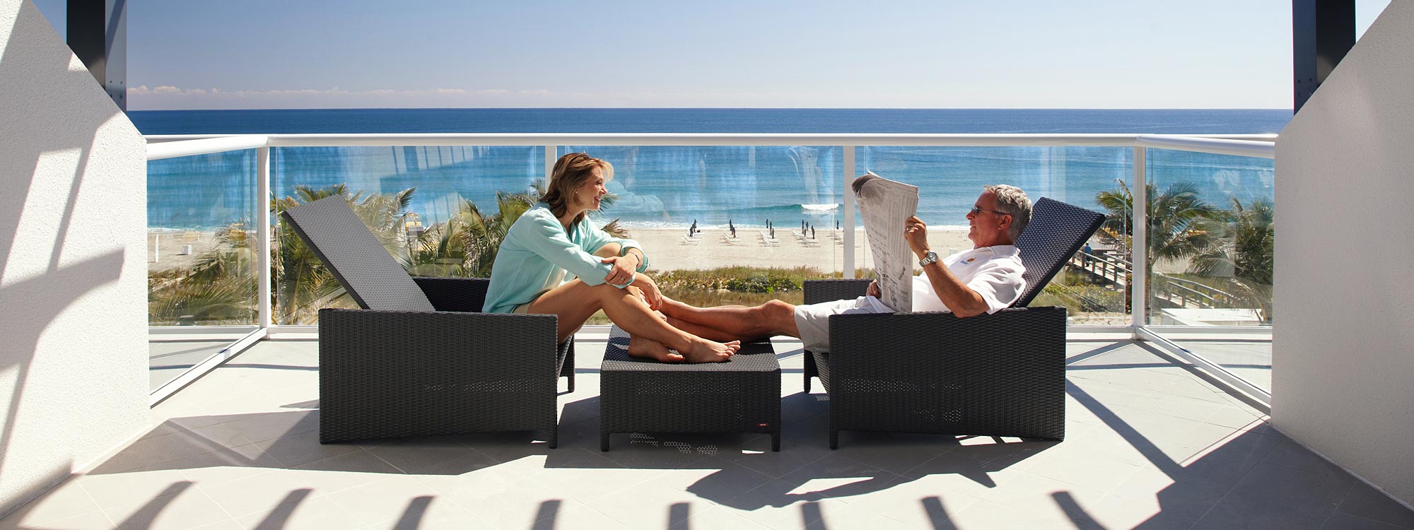 Image of couple relaxing and chatting on SOME modern outdoor furniture at Boca Beach Club USA