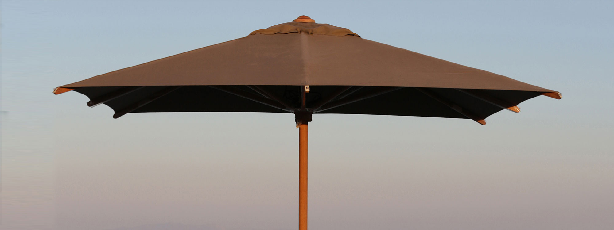 Image of Shady teak parasol by Royal Botania against sky at dusk