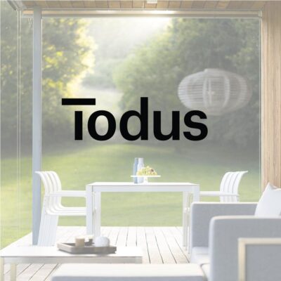 Image of Todus furniture logo overlaid over picture of white garden dining set