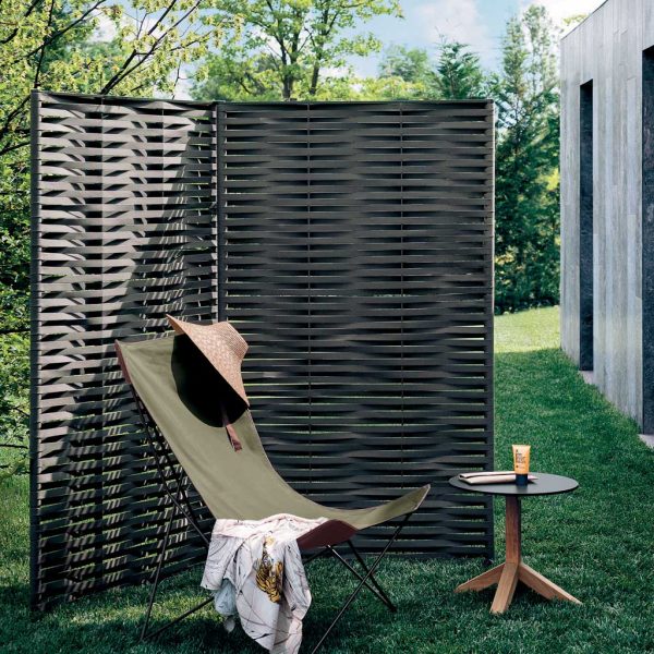 Image of RODA Wing exterior screen panels on lawn, together with Lawrence lounge chair and Root modern outdoor side table
