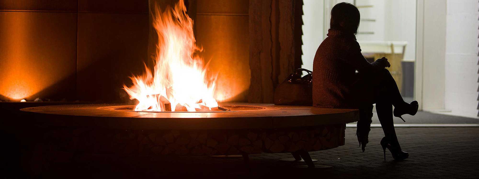 wood-burning-fire-pit-with-concrete-seat-and-log-storage.jpg
