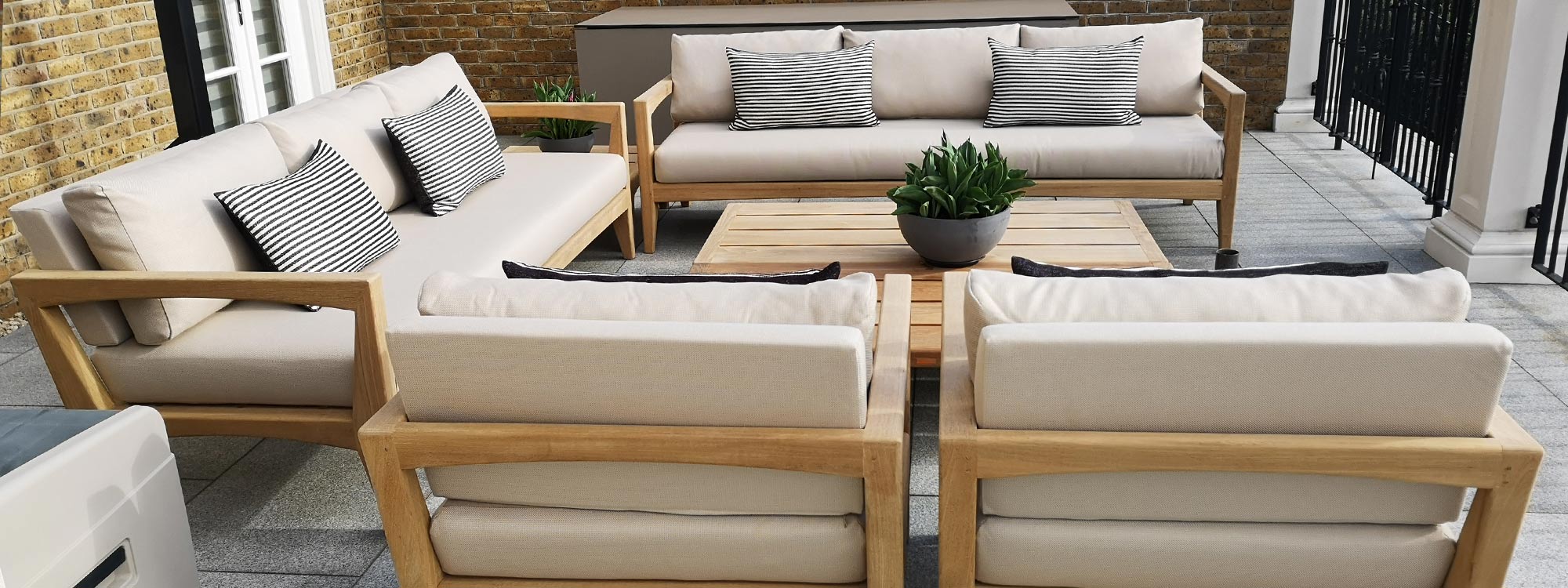 Image of chunky teak luxury garden sofa installation UK