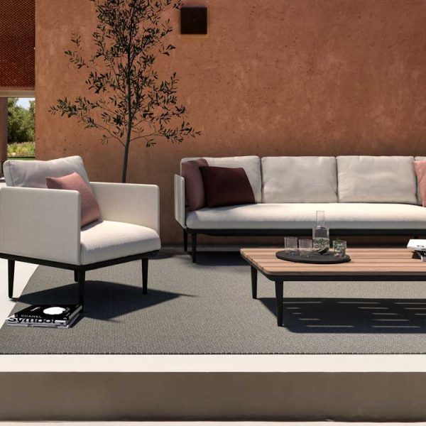 Image of Royal Botania corner sofa and lounge chair in terracotta-colored courtyard