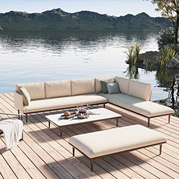 Balmy lakeside image of Royal Botania Styletto exterior corner sofa and low table on decking