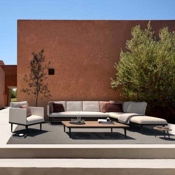 Styletto White garden sofa on terrace in front of terracotta wall