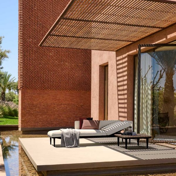 Styletto adjustable garden chaise longue by Royal Botania on minimalist terrace surrounded by water feature