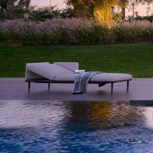 Dusk shot of Styletto upholstered sun loungers next to swimming pool
