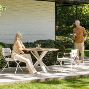 Traverse round folding garden table is a circular teak table & clever modern foldaway table shown here with Exes chairs, by Royal Botania outdoor furniture, Belgium.