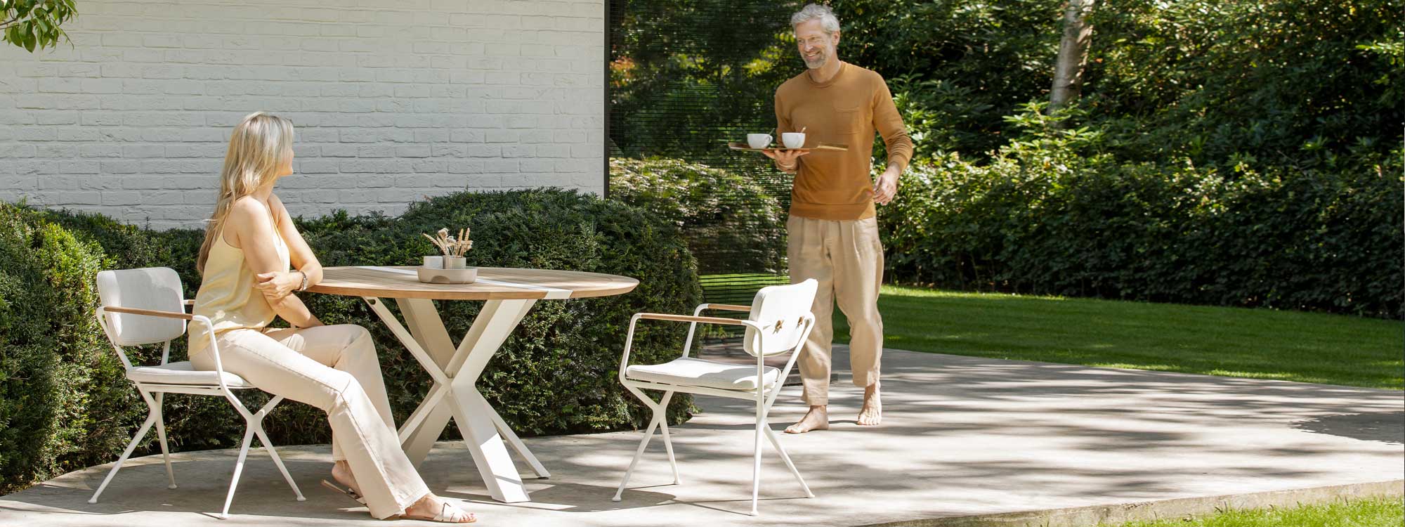 Image of white Traverse folding garden table and white Exes garden chairs by Royal Botania
