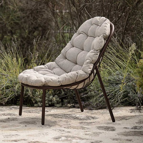 Image of Todus Albus garden easy chair and cushion on terrace, with lavender in background