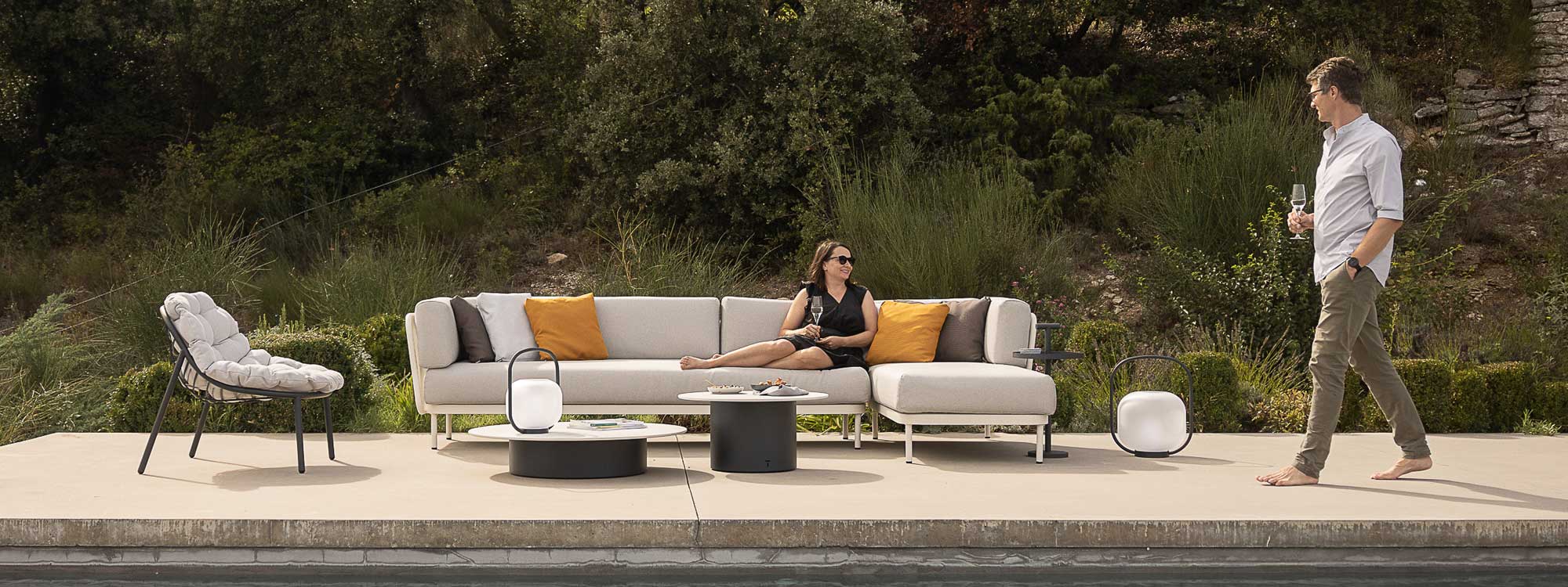 Image of Baza white garden sofa and Albus dark-grey garden lounge chair on sunny poolside