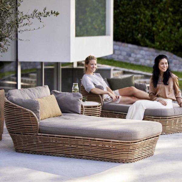 Image of women relaxing on natural cane Basket daybeds with cozy taupe cushions by Caneline