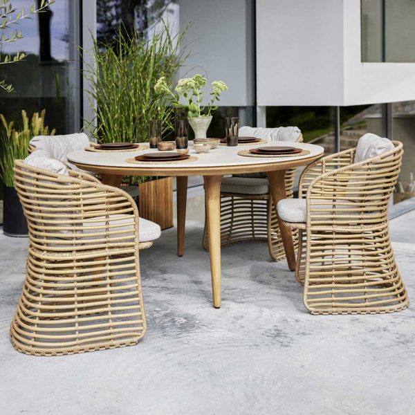 Image of Aspect circular teak dining table and Basket natural bamboo chairs by Cane-line
